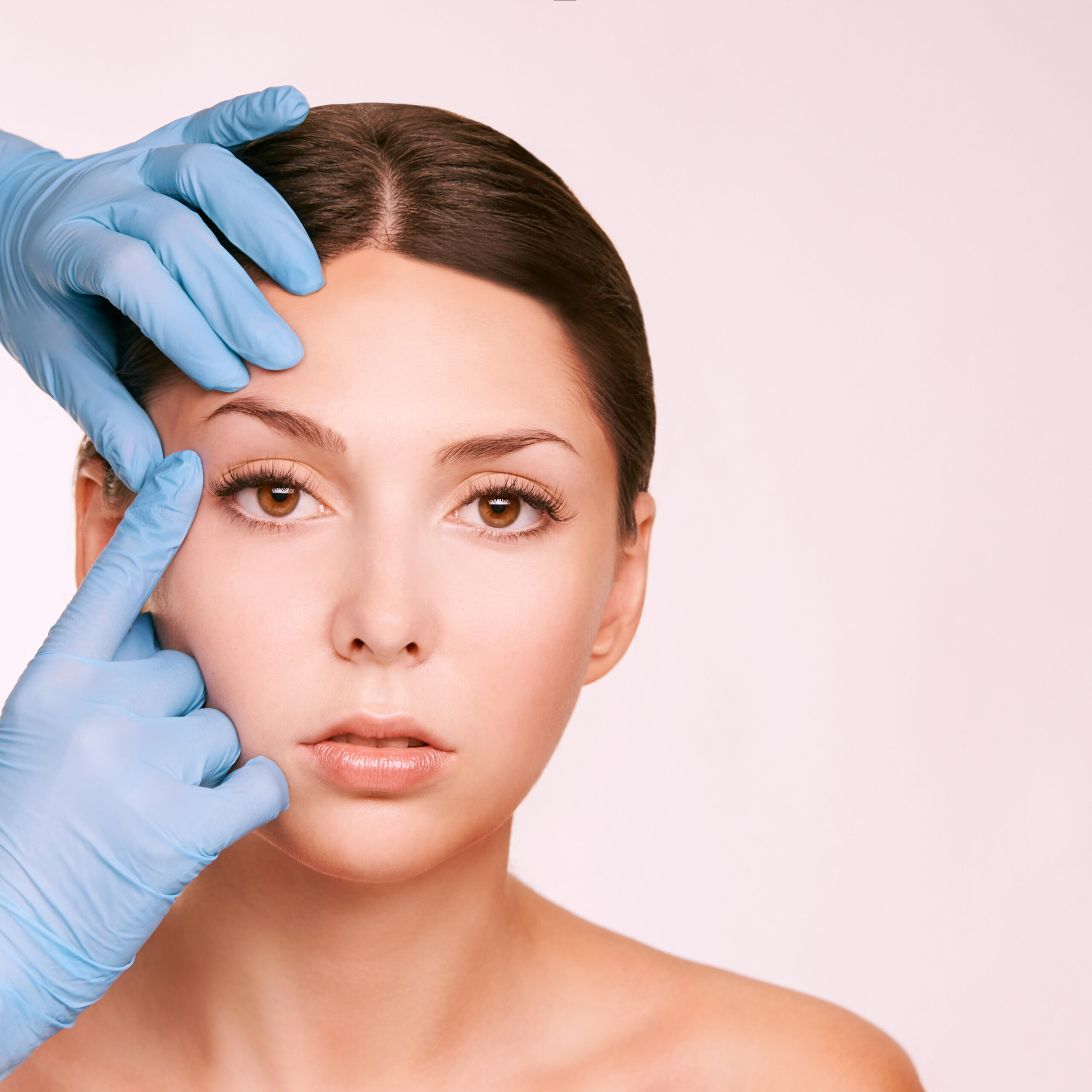 Doctor in gloves touch woman face.  Facial brow lift surgery